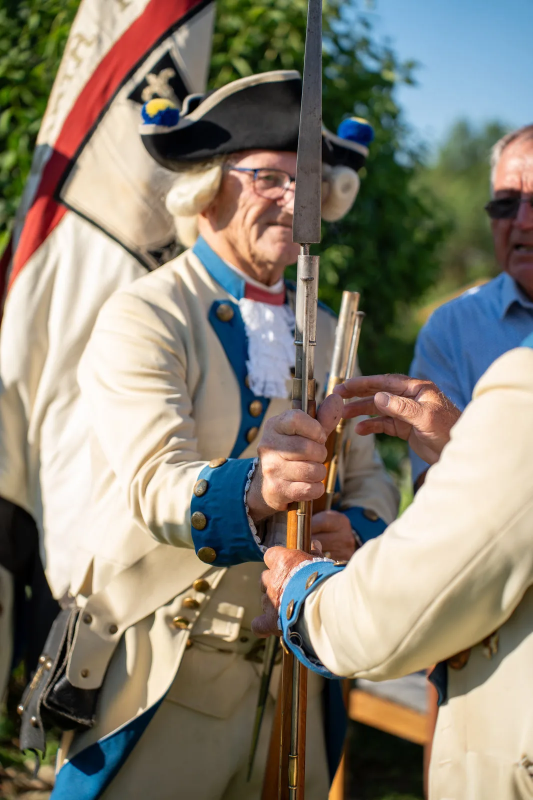 Zwei Gardisten im Gespräch über eine Muskete mit aufgepflanztem Bajonett.